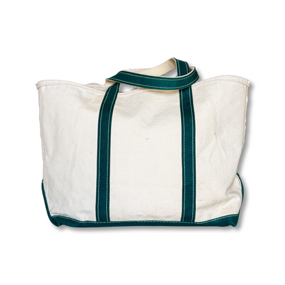 White tote bag with green straps on a white background