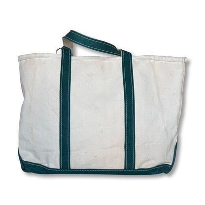 White tote bag with green edges on a white background