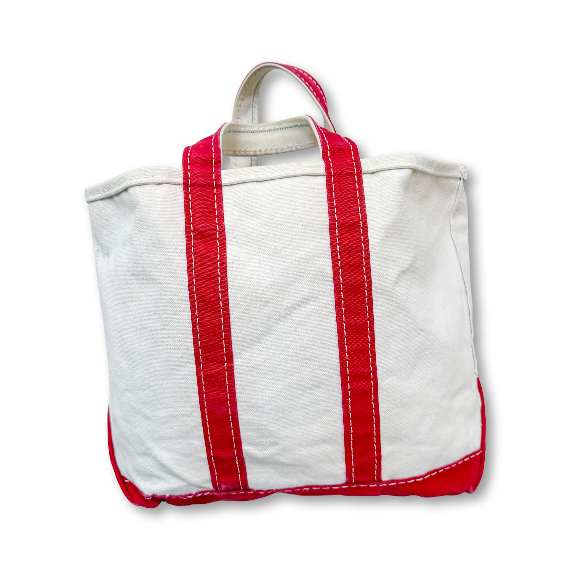 White tote bag with red straps on a white background