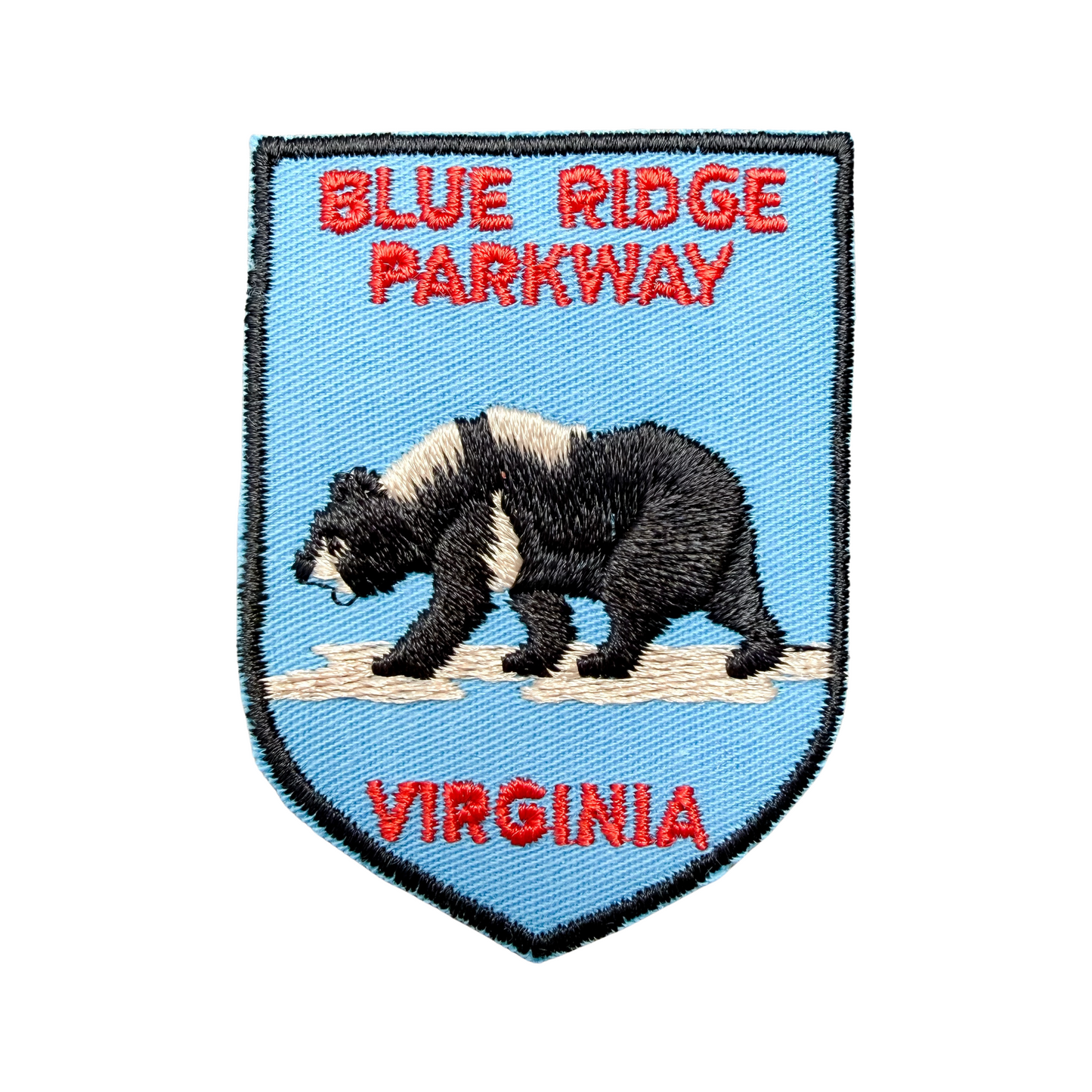 Embroidered patch with a bear, 'Blue Ridge Parkway', and 'Virginia' text on a blue background.