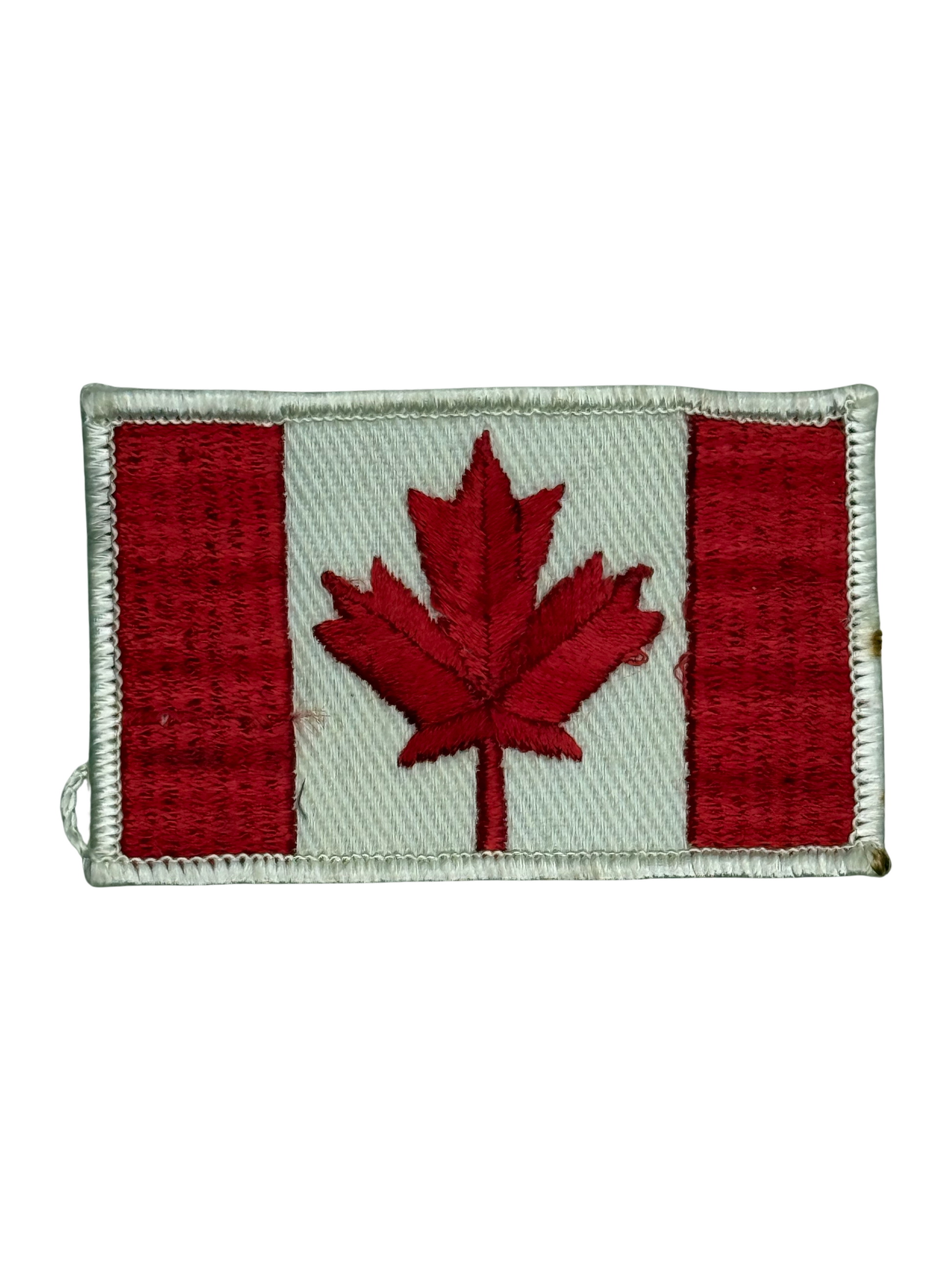 Embroidered patch of the Canadian flag on a white background
