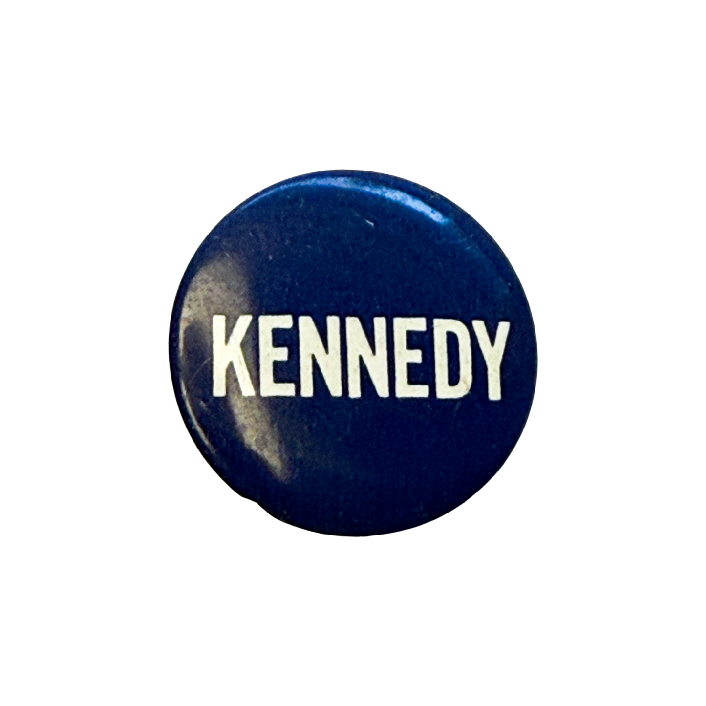 Navy blue button with 'KENNEDY' printed in white on a white background