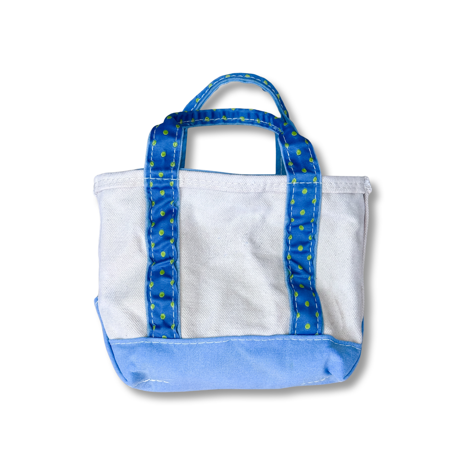 White tote bag with blue handles and trim on a white background
