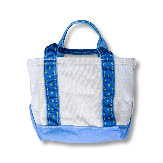 White tote bag with blue trim and handle on a white background