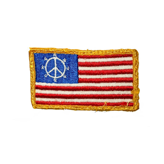 Patch with American flag design and peace symbol on a white background
