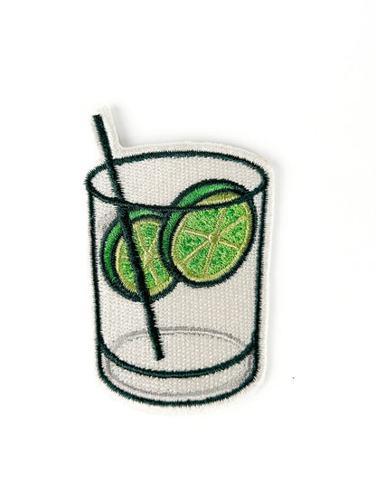 Embroidered patch of a glass with lime slices and a straw on a white background