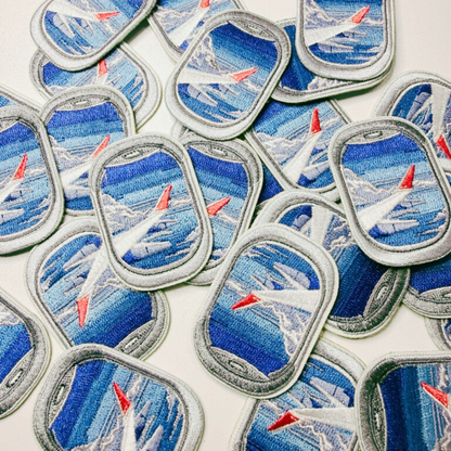 Collection of airplane-themed patches on a white background