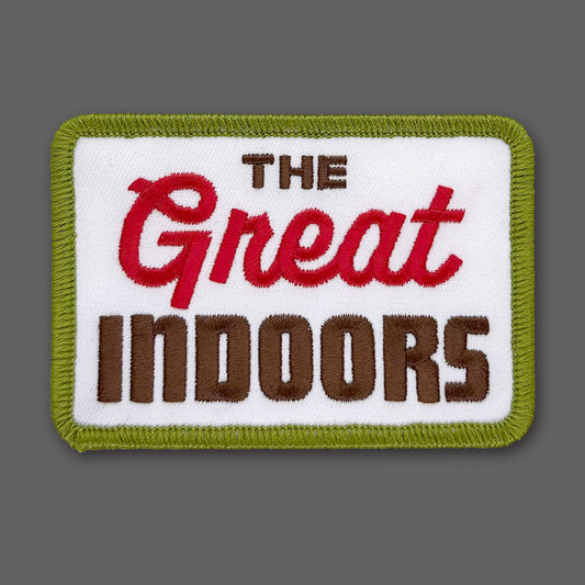 Embroidered patch with 'The Great Indoors' text on a white background with green border