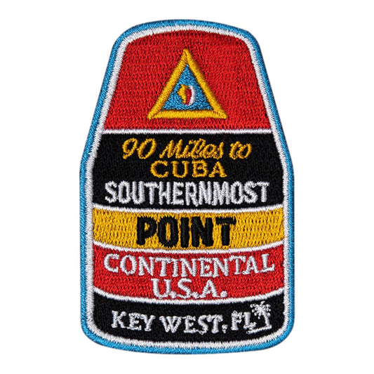 Patch with text and a triangle logo on a red, black, and yellow background