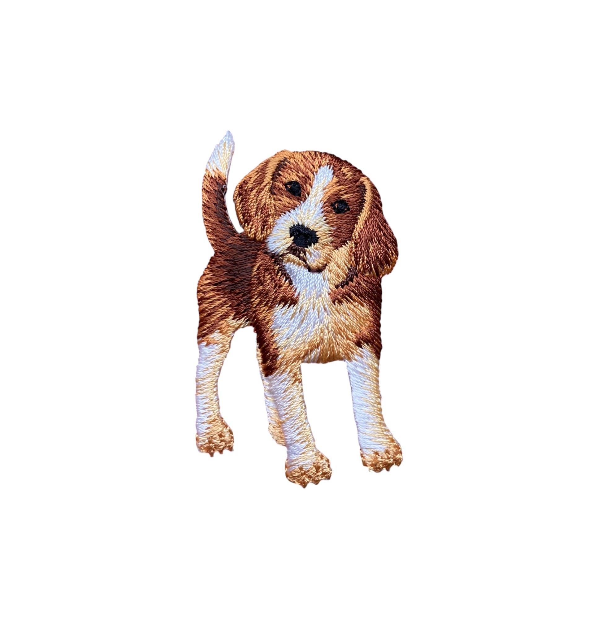 Embroidered patch of a brown and white beagle on a white background