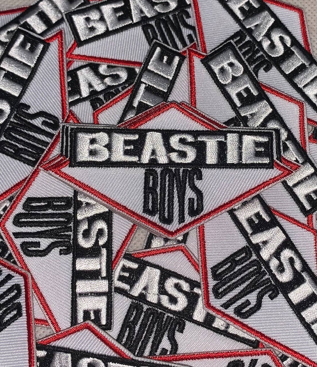 Multiple patches with 'Beastie Boys' text on a gray background