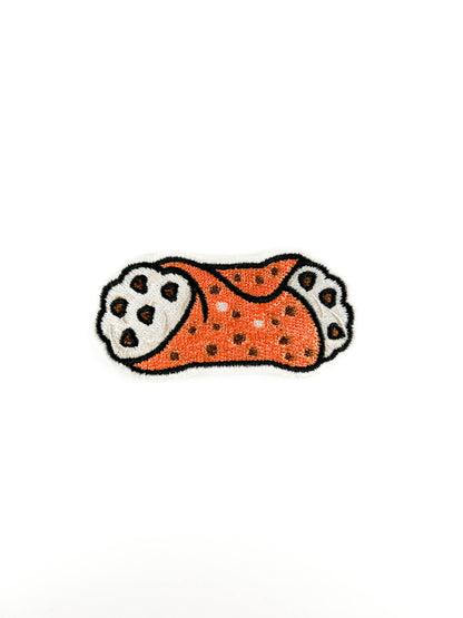 Embroidered patch of a CANNOLI with chocolate chips on a white background