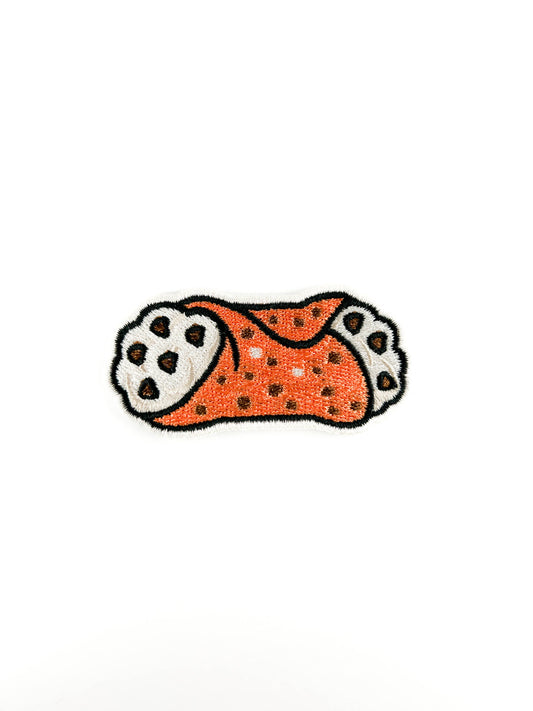 Embroidered patch of a CANNOLI with chocolate chips on a white background