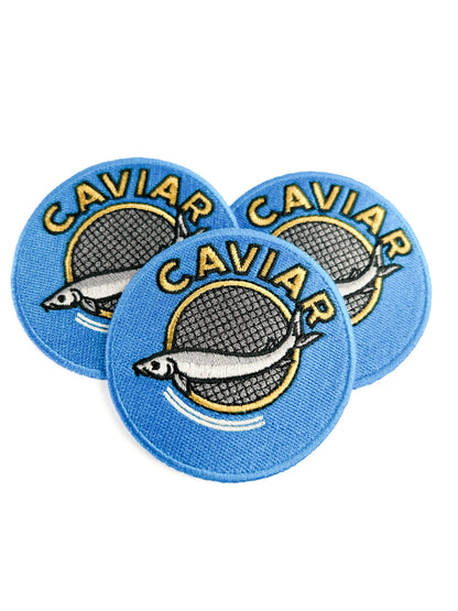 Three round blue patches with 'CAVIAR' text and fish illustration on a white background