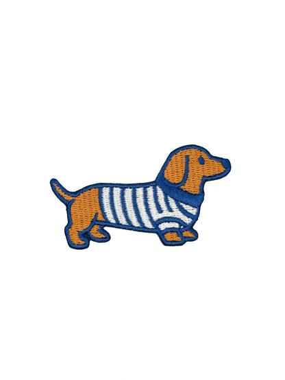 Embroidered patch of a dachshund wearing a sweater on a white background