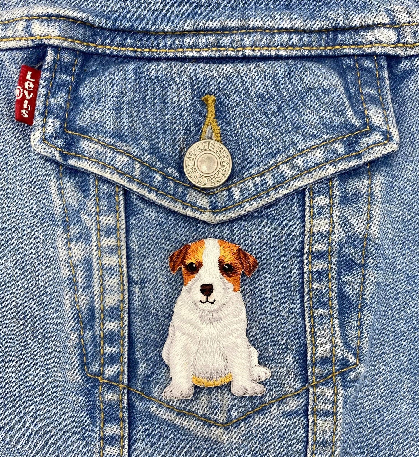 Denim jacket with a dog patch on the pocket