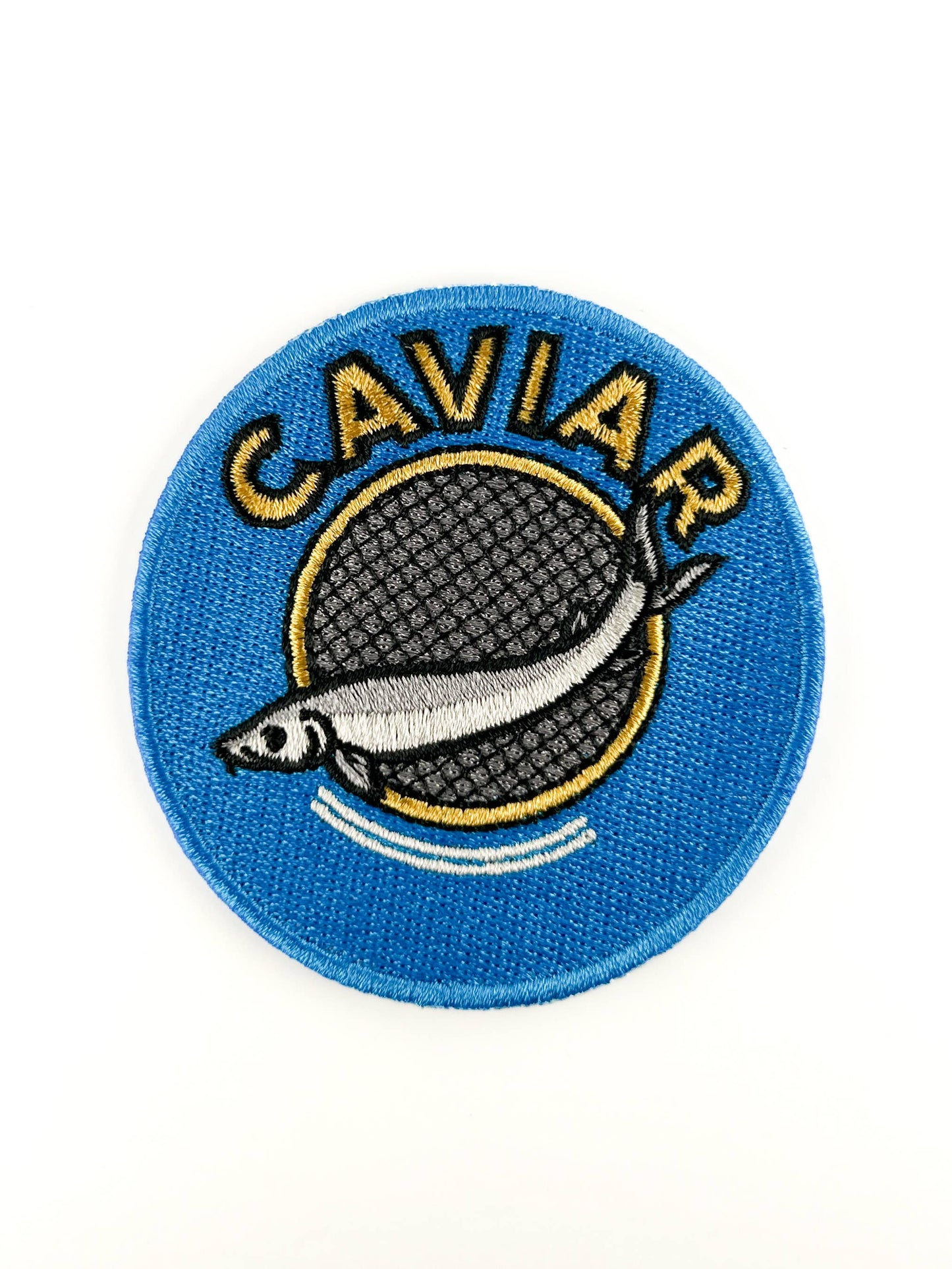Patch with caviar design on a blue background, on a white background