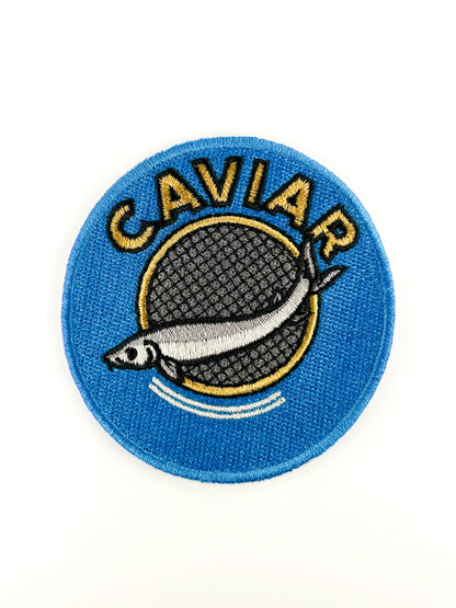Patch with caviar design on a blue background, on a white background