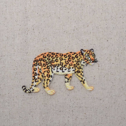 Embroidered patch of a leopard on a textured fabric background