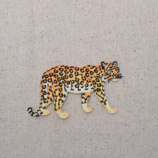 Embroidered patch of a leopard on a textured fabric background
