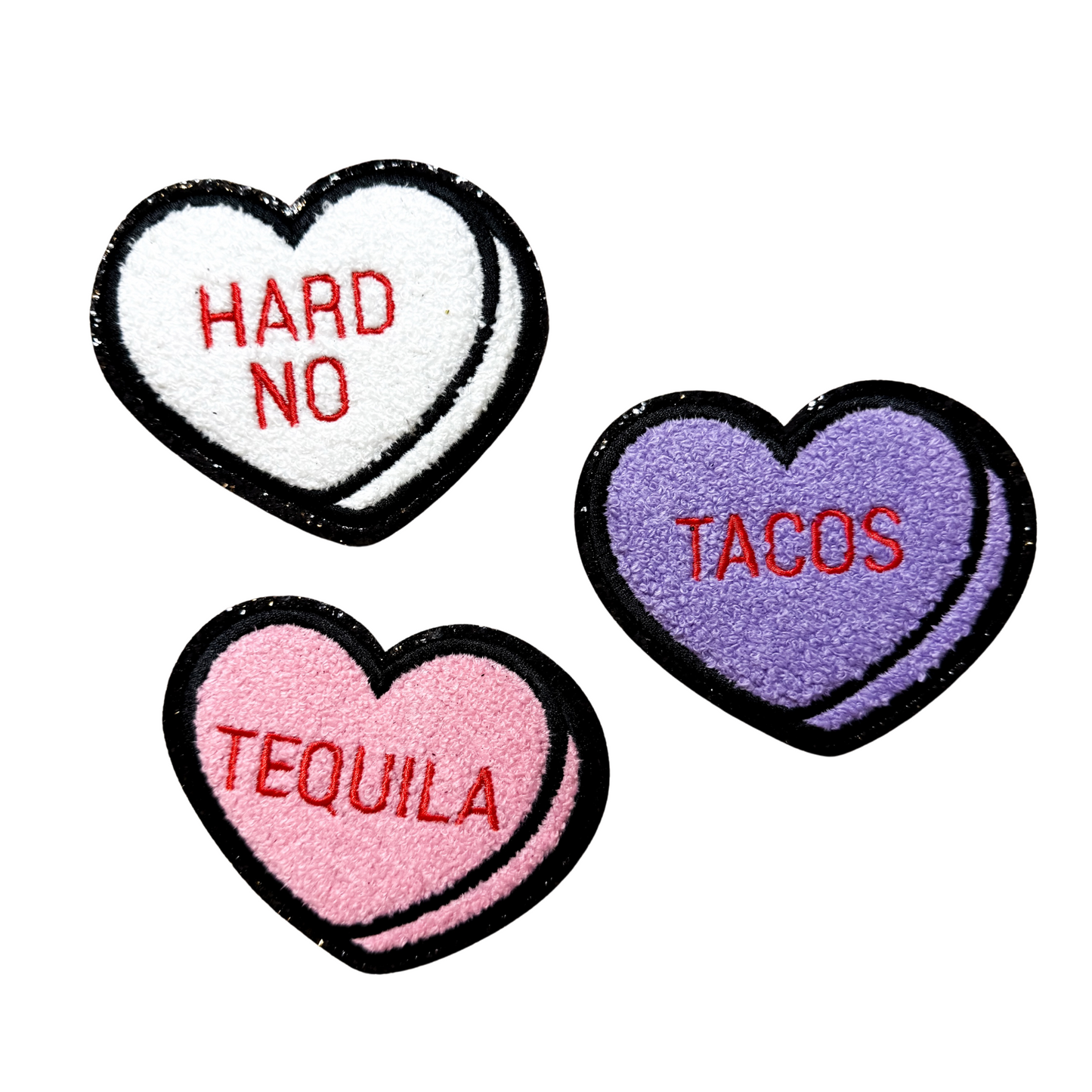 Three heart-shaped patches with 'HARD NO', 'TACOS', and 'TEQUILA' text on a white background.