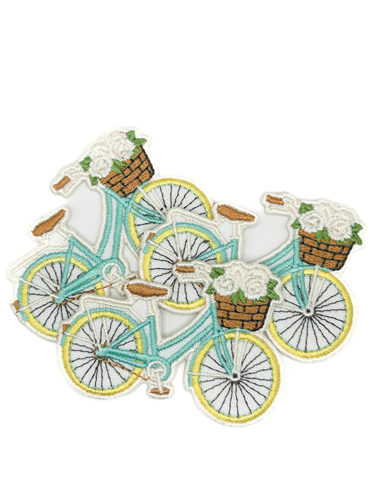 Set of bicycle patches with flower baskets on a white background