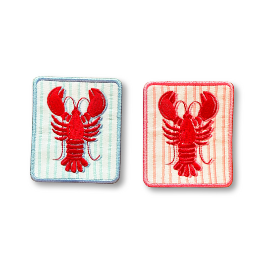 Two red lobster patches on striped backgrounds, one blue and one pink