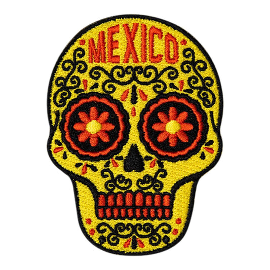 Colorful yellow skull design with 'Mexico' text on a white background