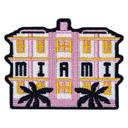 Embroidered patch of a pink building with 'Miami' and palm trees on a white background