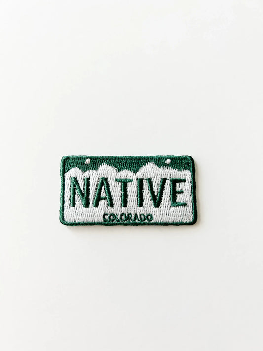 Embroidered patch license plate design with 'NATIVE COLORADO' text on a white background