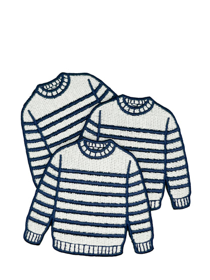 Three striped sweaters in navy and cream on a white background
