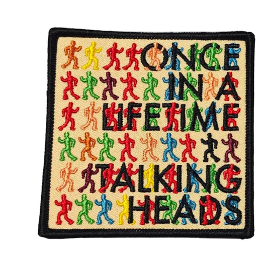 Patch that reads "ONCE IN A LIFETIME TALKING HEADS" with colorful silhouettes on a white background