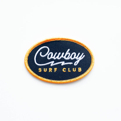 Embroidered patch with 'Cowboy Surf Club' text on a blue background
