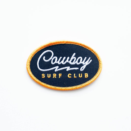 Embroidered patch with 'Cowboy Surf Club' text on a blue background