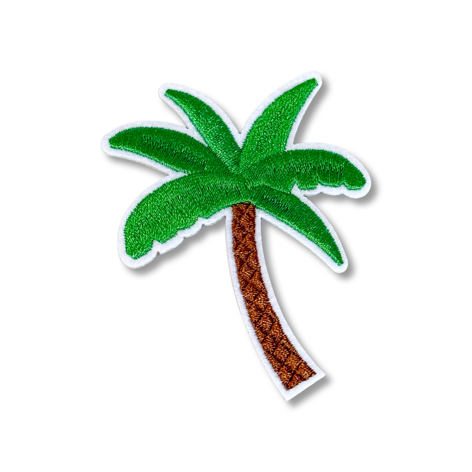 Embroidered palm tree design on a white background