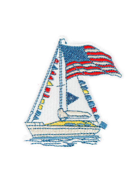Embroidered sailboat patch with an American flag on a white background