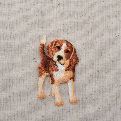 Embroidered patch of a dog on a textured fabric background