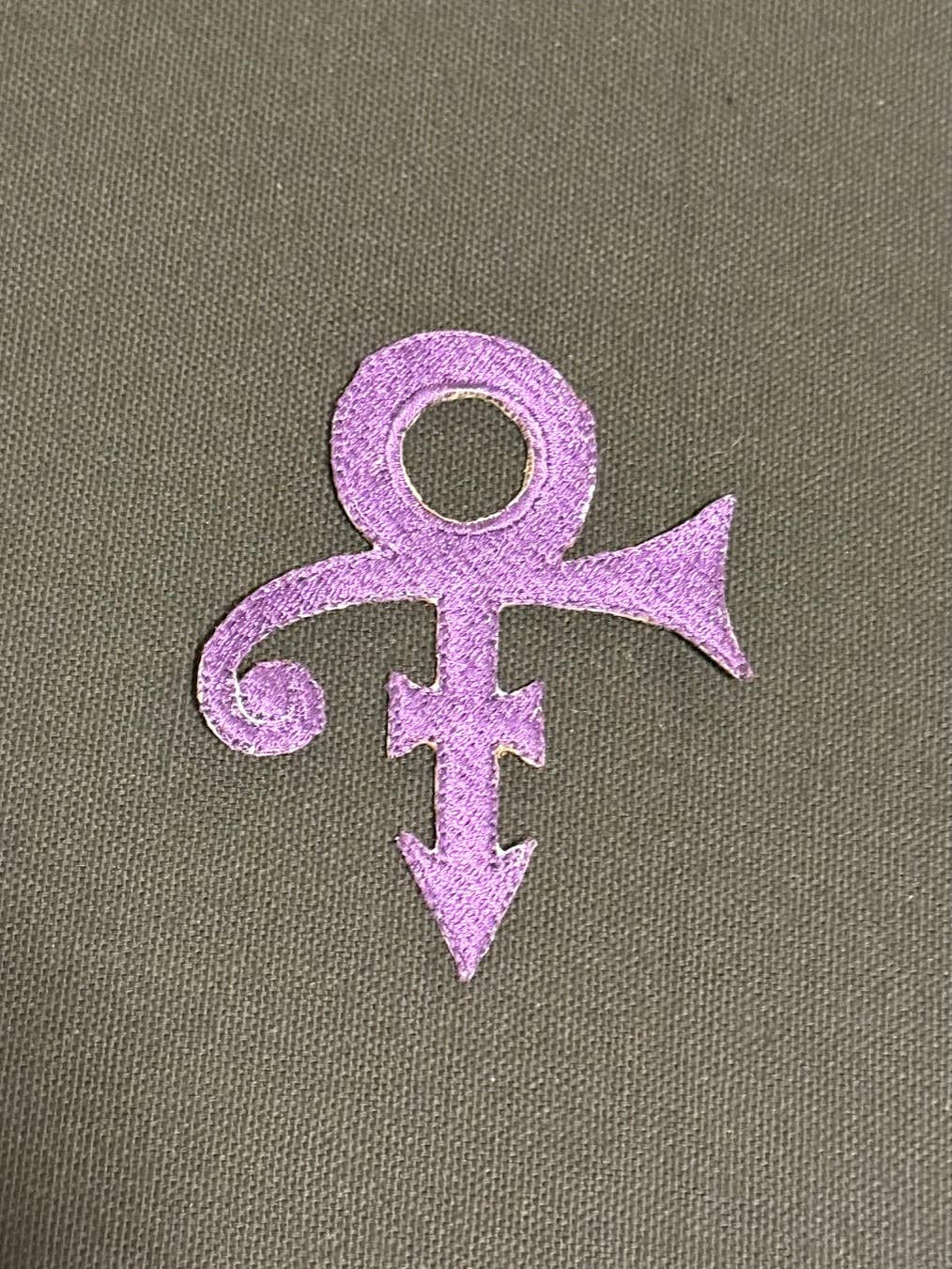 Purple symbol on a textured grey background