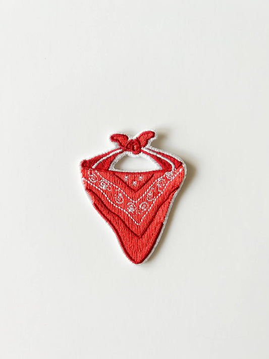 Red bandana with white patterns on a light gray background