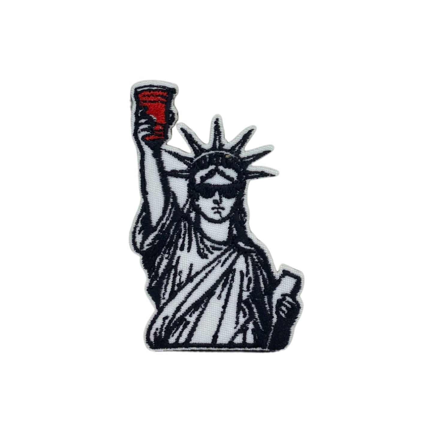 Patch of the Statue of Liberty holding a red cup and wearing sunglasses on a white background