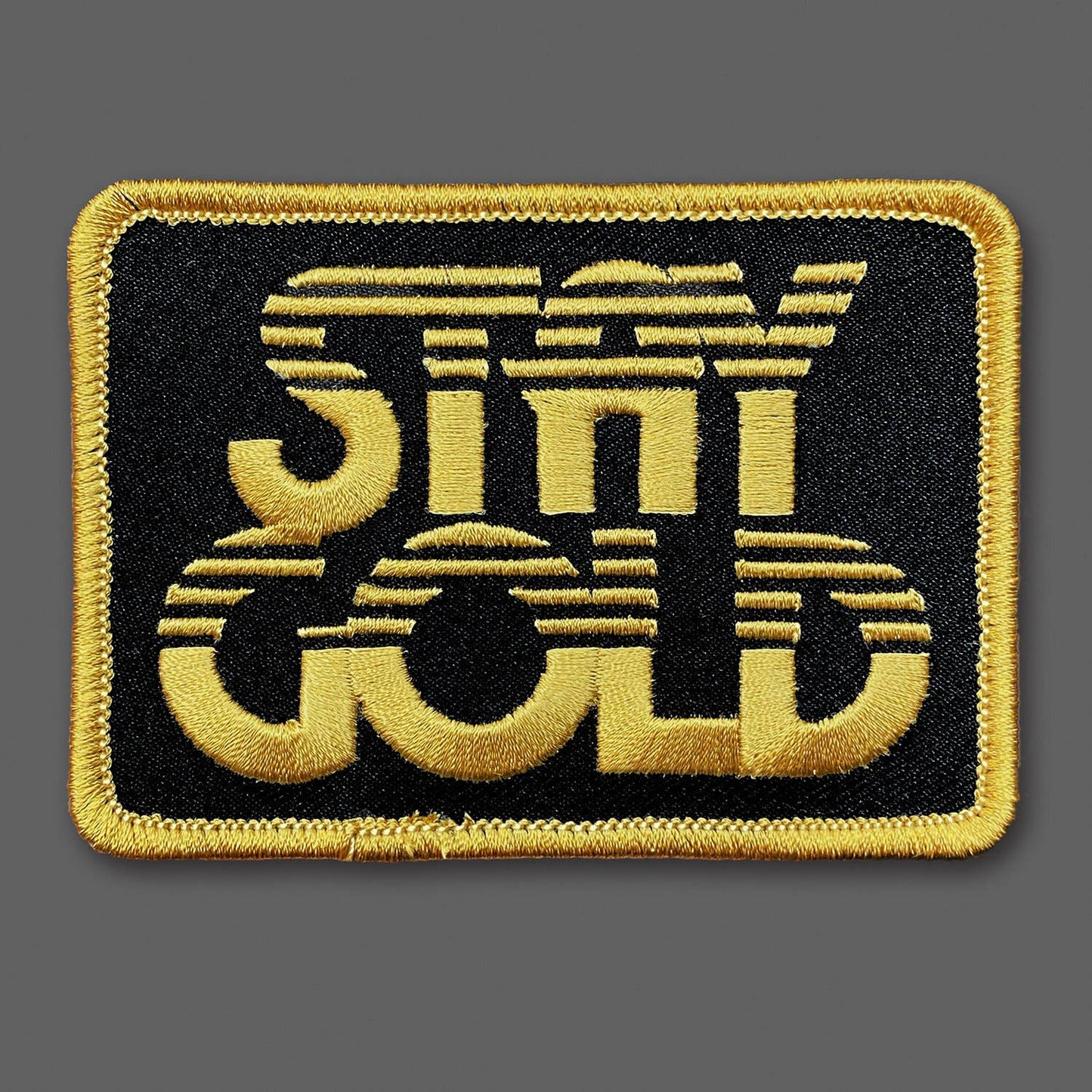 Embroidered patch with 'Stay Gold' text on a black background