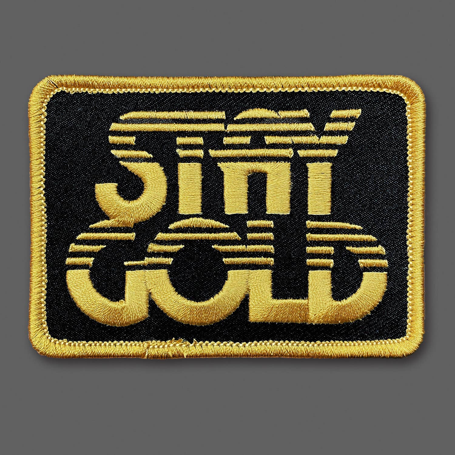 Embroidered patch with 'Stay Gold' text on a black background