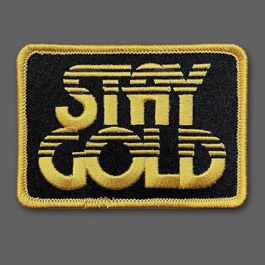Embroidered patch with 'Stay Gold' text on a black background