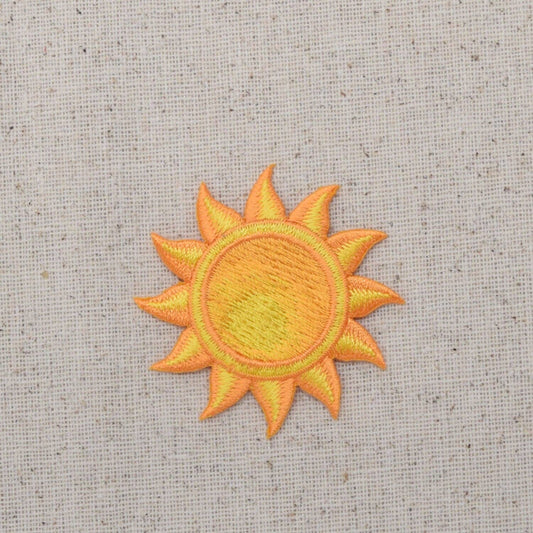 Embroidered sun patch on a textured fabric background