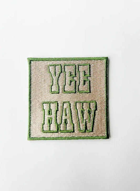 Embroidered patch with "YEE HAW" text on a white background