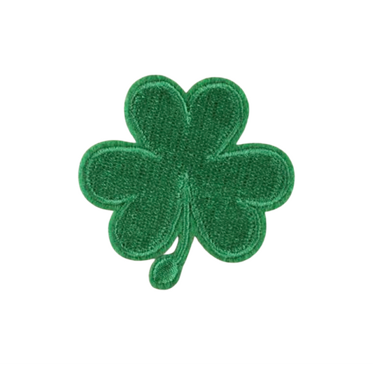 Green four-leaf clover patch on a white background