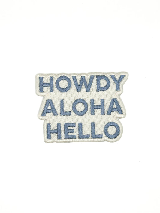 Embroidered patch with 'HOWDY ALOHA HELLO' text on a white background