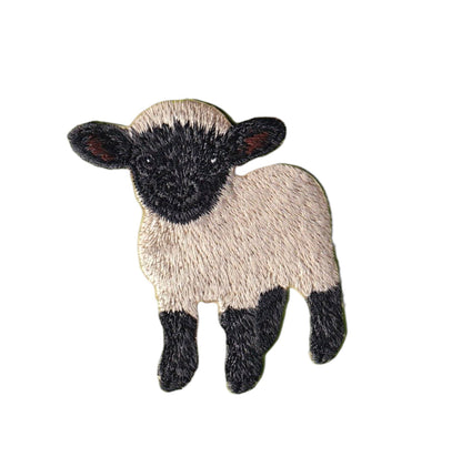 An embroidered patch of a black-faced sheep with cream-colored wool and black legs, shown on a plain white background.