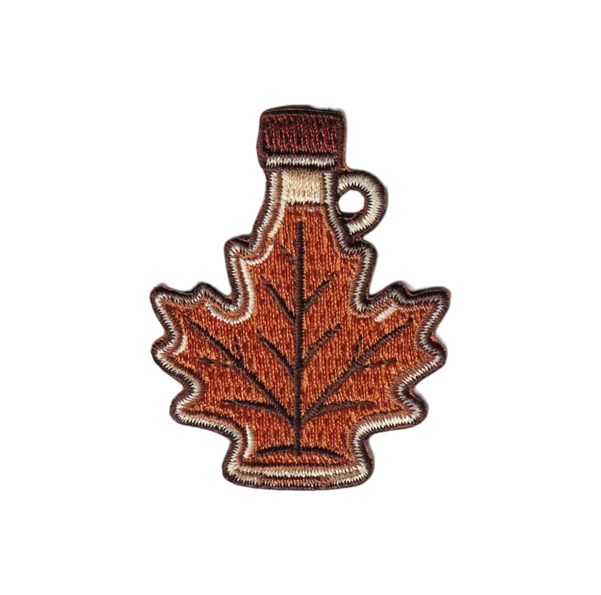 An embroidered iron-on patch shaped like a maple leaf, styled as a bottle with a brown cap and handle, featuring orange-brown, brown, and beige colors on a white background.