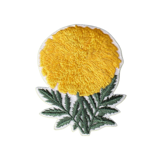 An embroidered patch featuring a bright yellow flower with textured yellow stitching, dark green leaves, and a white embroidered border, shown on a plain white background.
